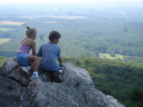 Children sitting on a rock at Sugarloaf Mountain